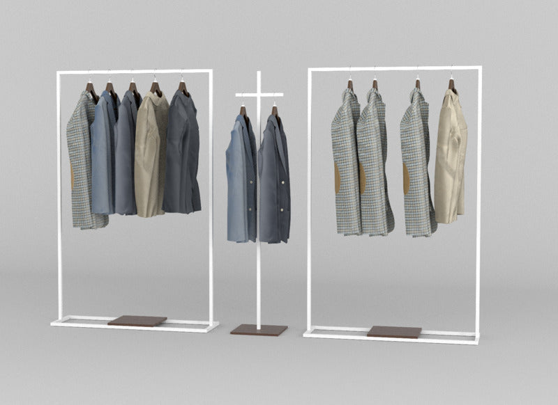 ミニマルショールームに置かれた白いメタル製ハンガーラックとジャケット